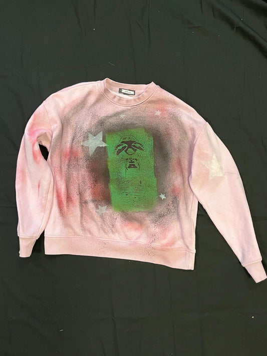 Pink sweatshirt with green cartoon print