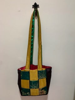 Green and yellow lattice. Long strap. Red interior