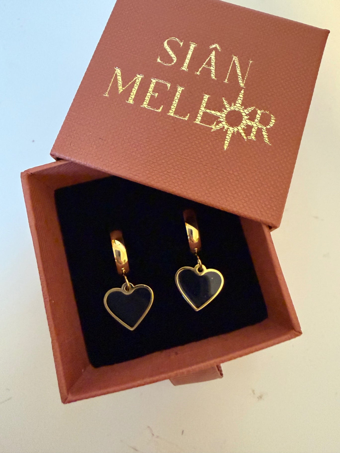 Black and gold heart hoop earrings