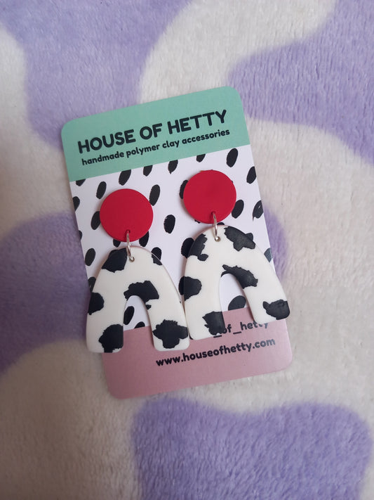 Polymer clay cow print arch earrings