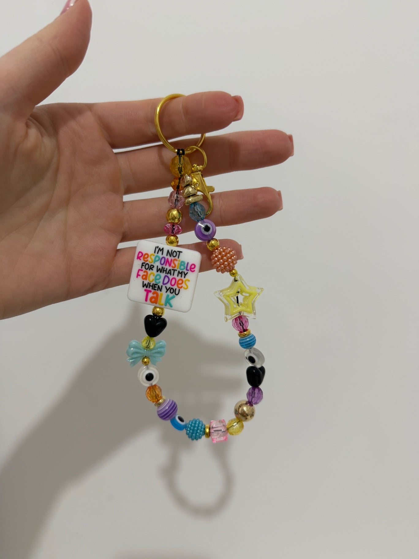 ‘Not responsible for my face’ Keyring - gold 