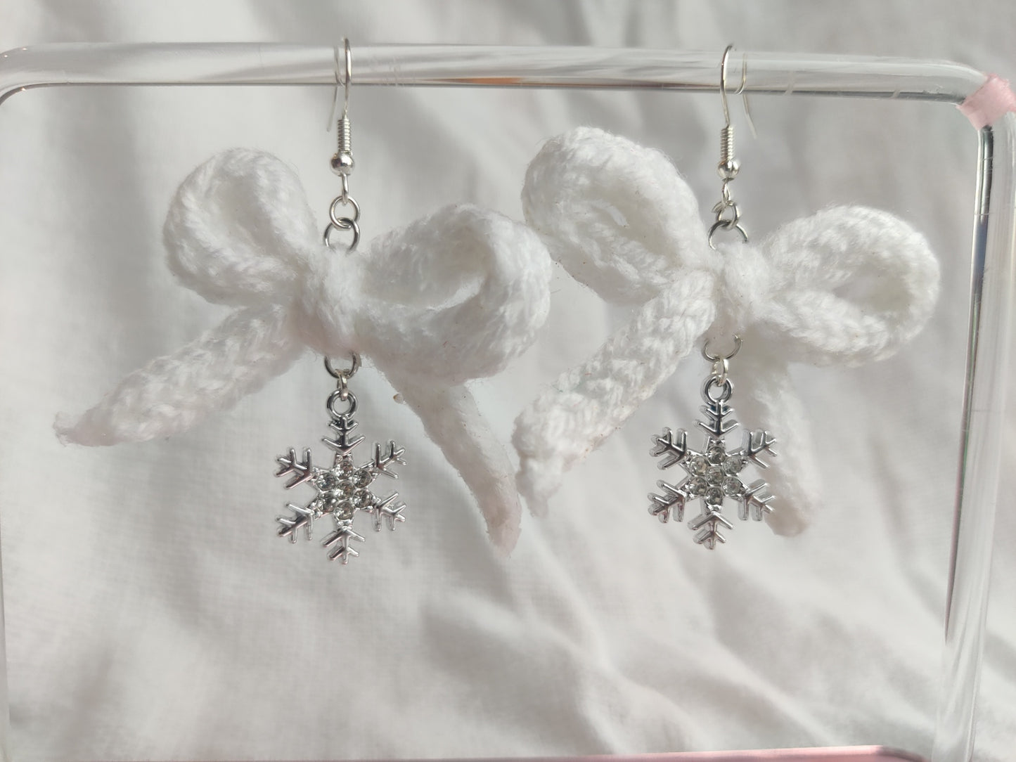 White crochet bows with sparkly snowflake charms