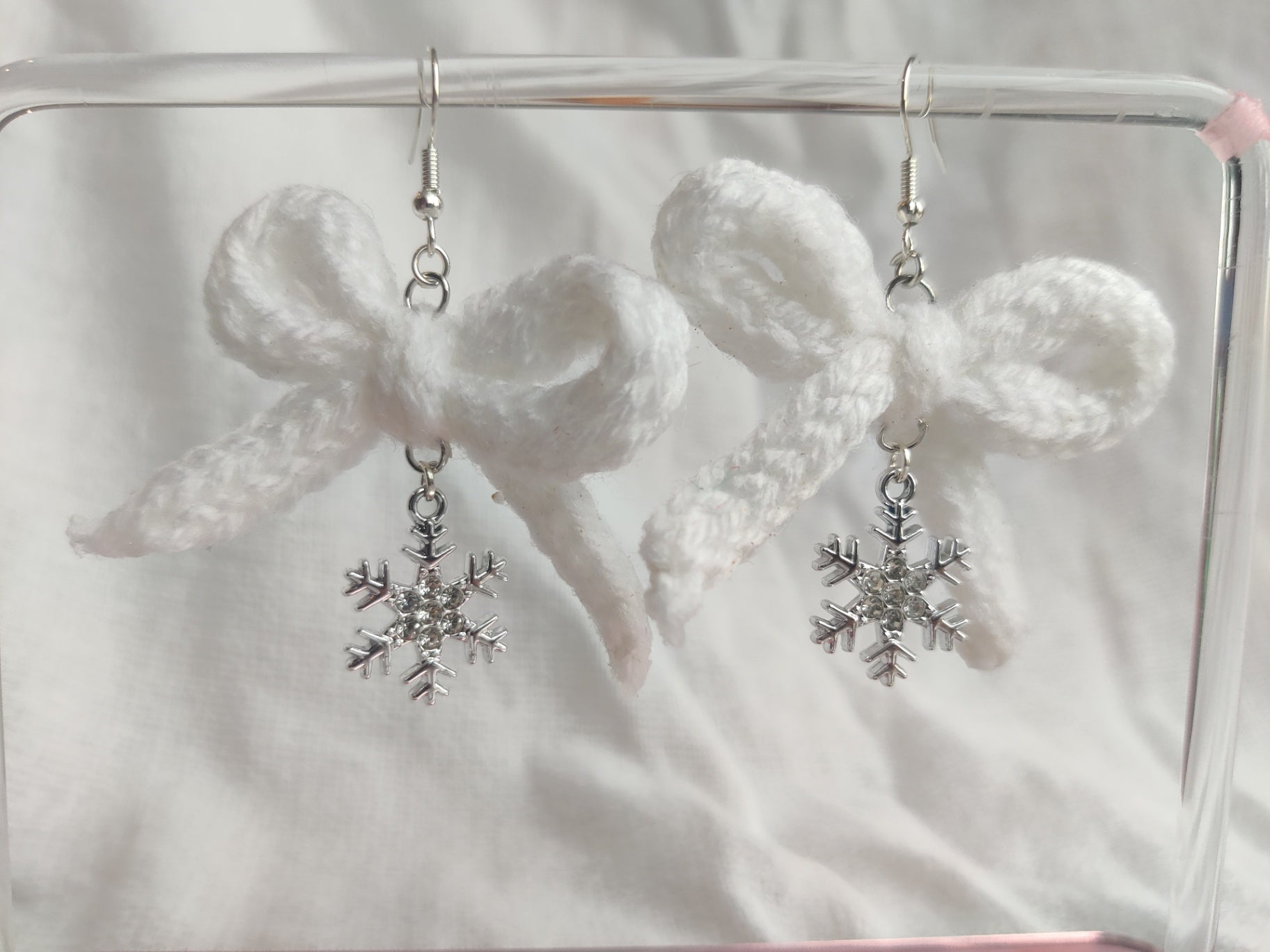 White crochet bows with sparkly snowflake charms
