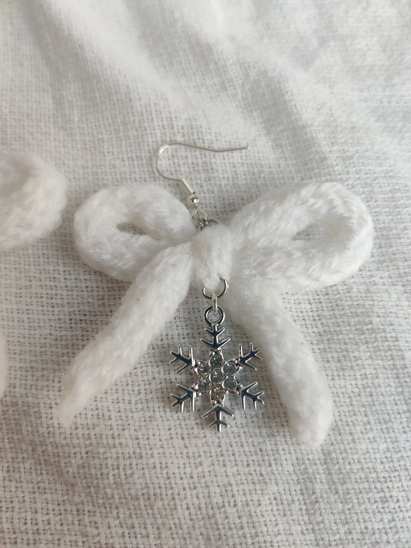 White crochet bows with sparkly snowflake charms