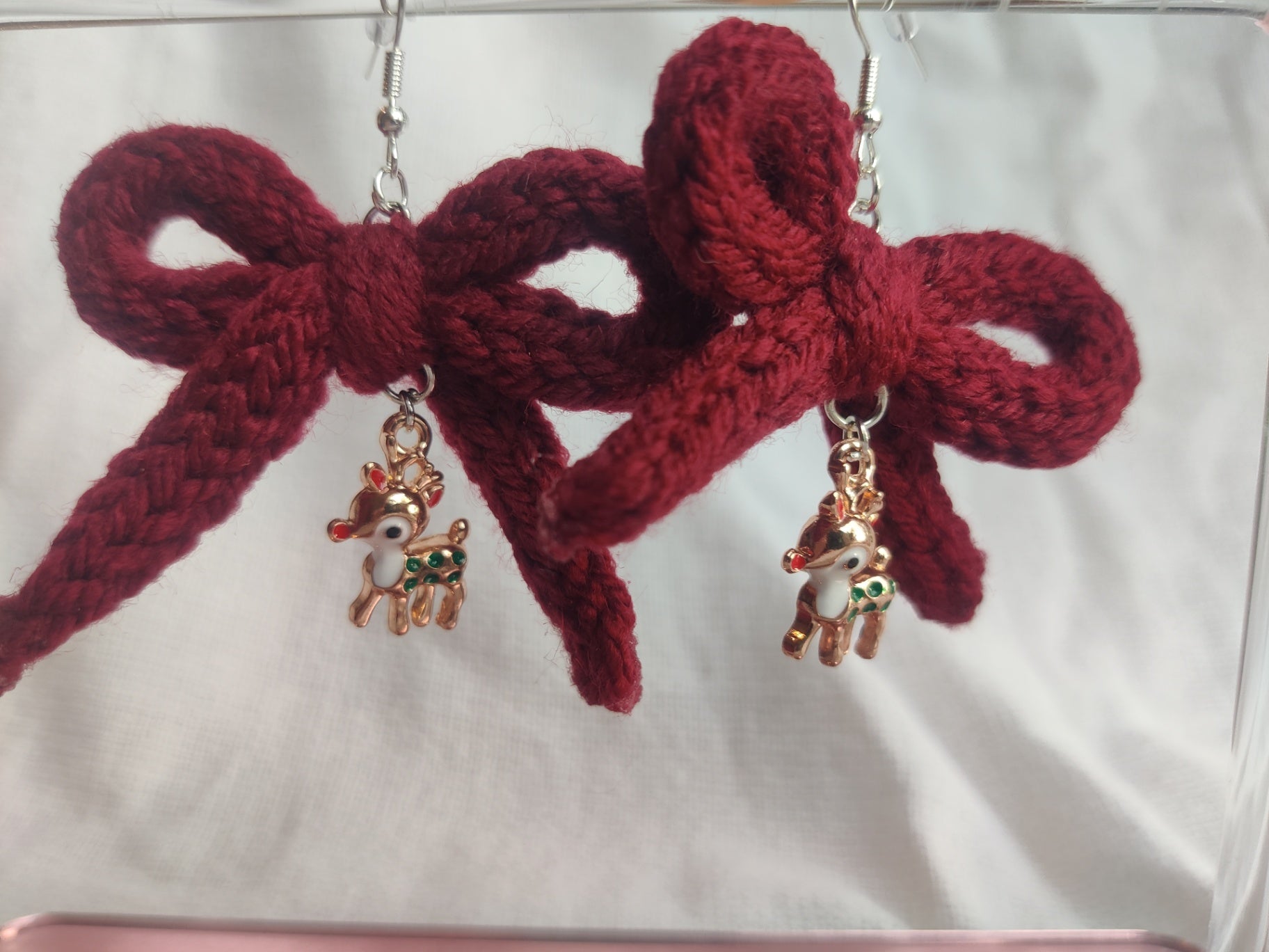 Crochet burgundy bow earrings with reindeer charms