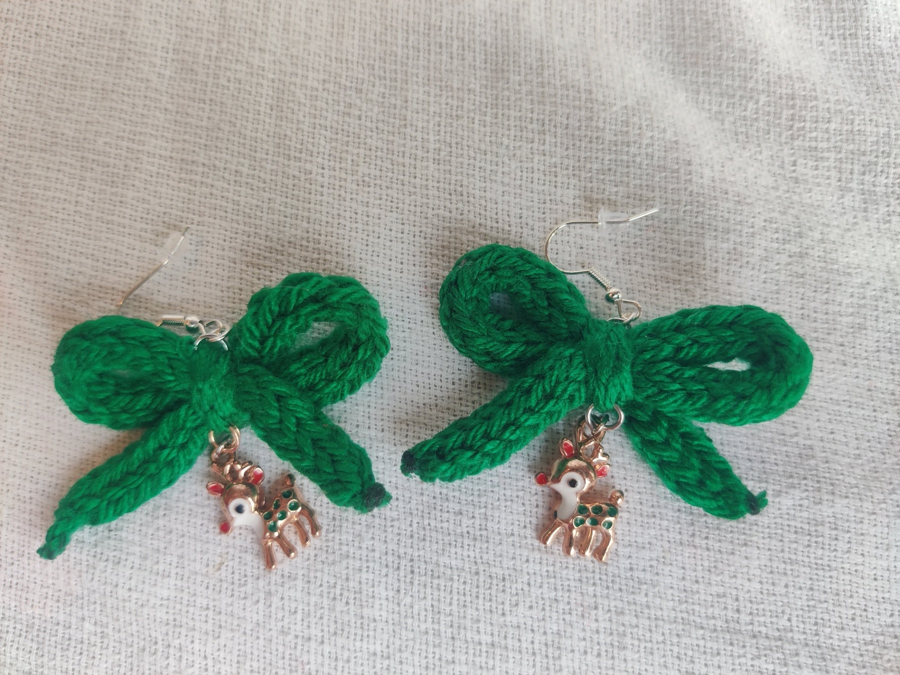 Crochet green bow earrings with reindeer charms