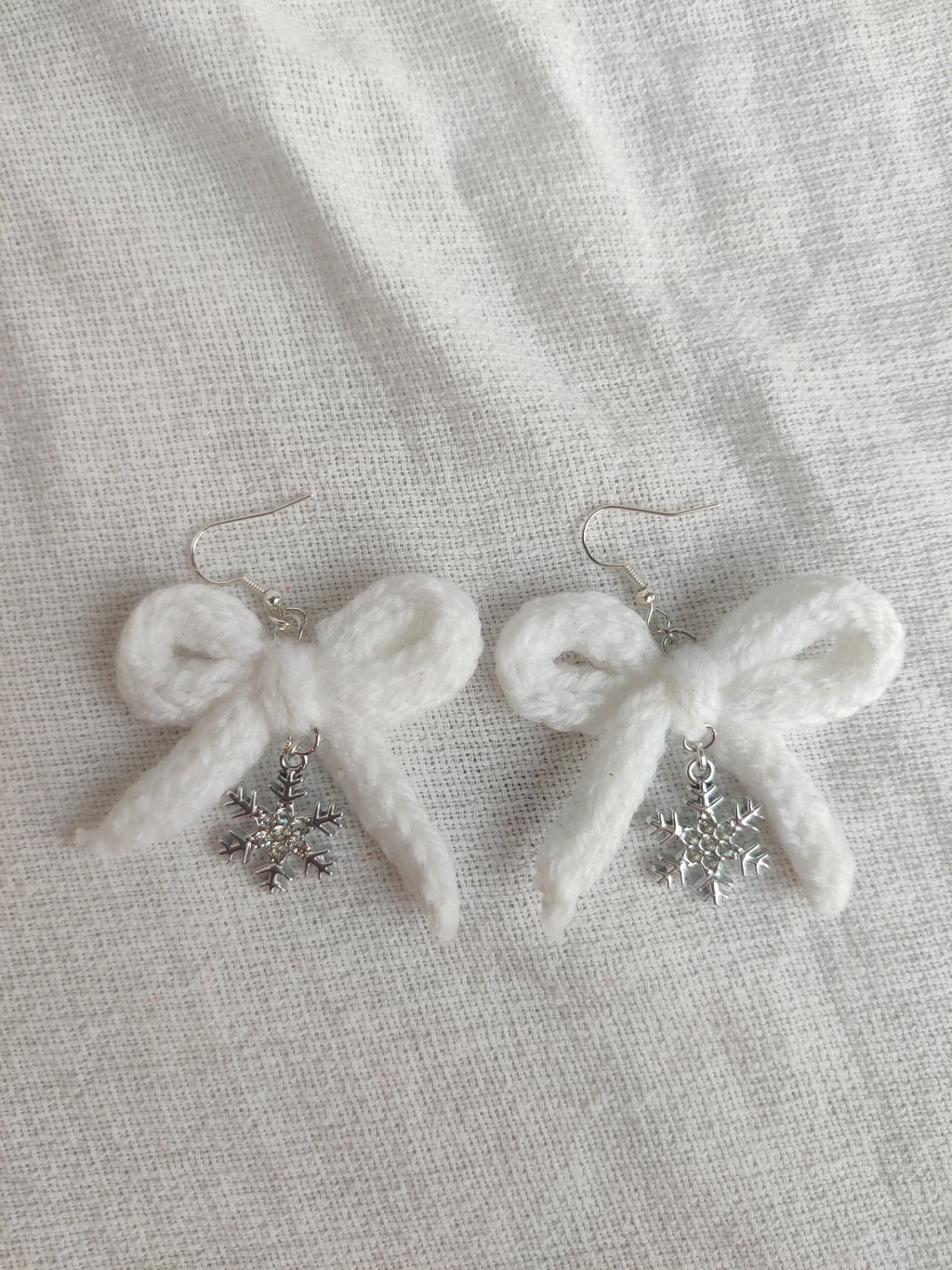 White crochet bows with sparkly snowflake charms
