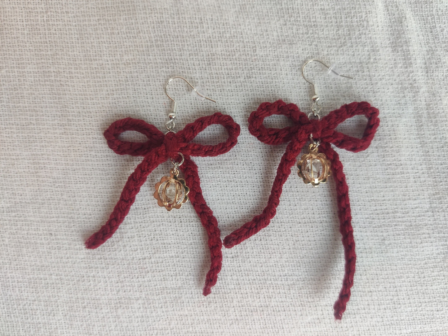 Crochet burgundy bows with golden sparkly charms