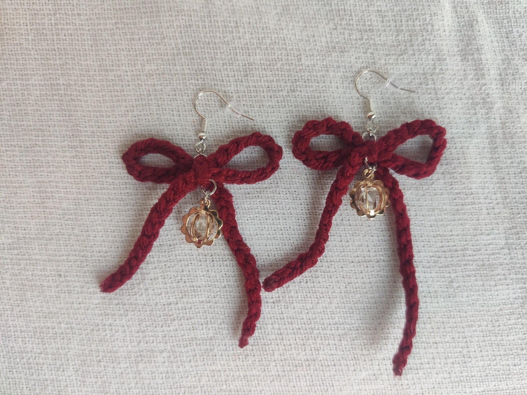 Crochet burgundy bows with golden sparkly charms