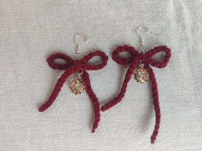 Crochet burgundy bows with golden sparkly charms