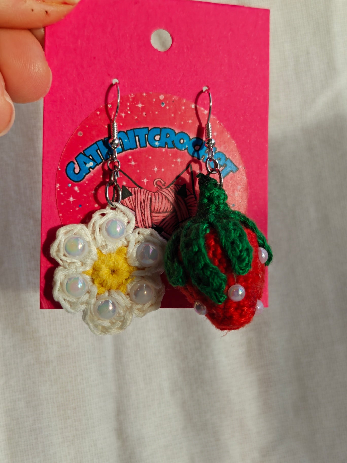 Mismatched earrings, strawberry and flower