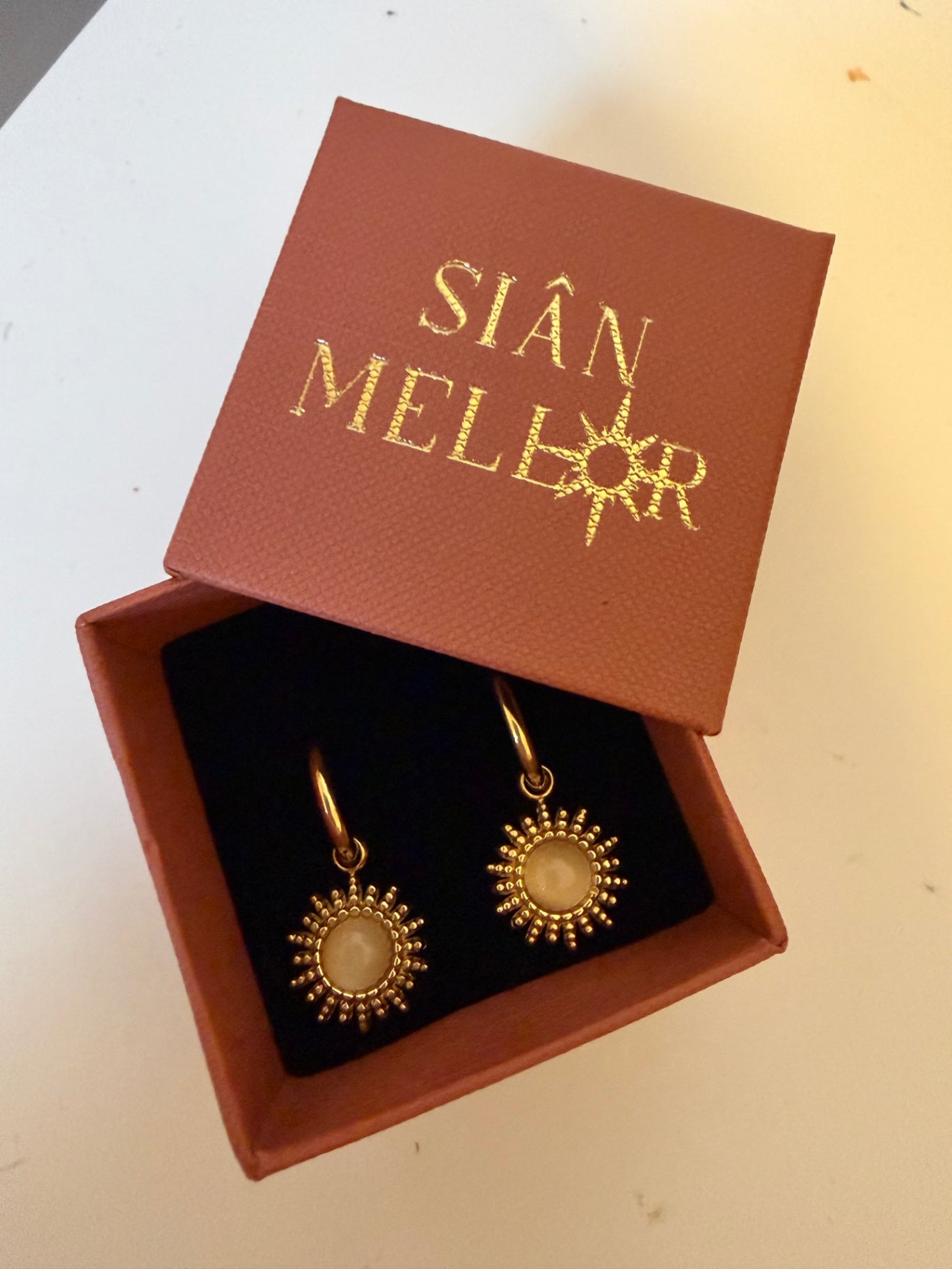 White and gold sun hoop earrings 