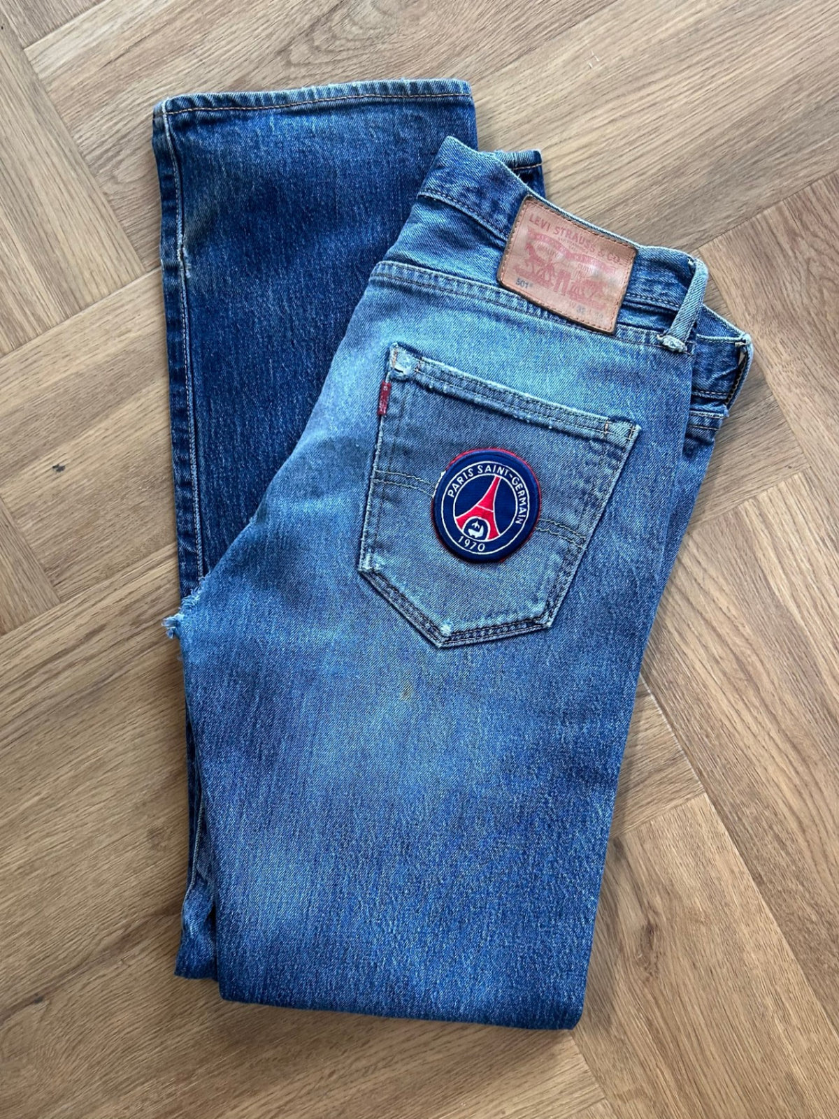 Upcycled Levi's with PSG logo.